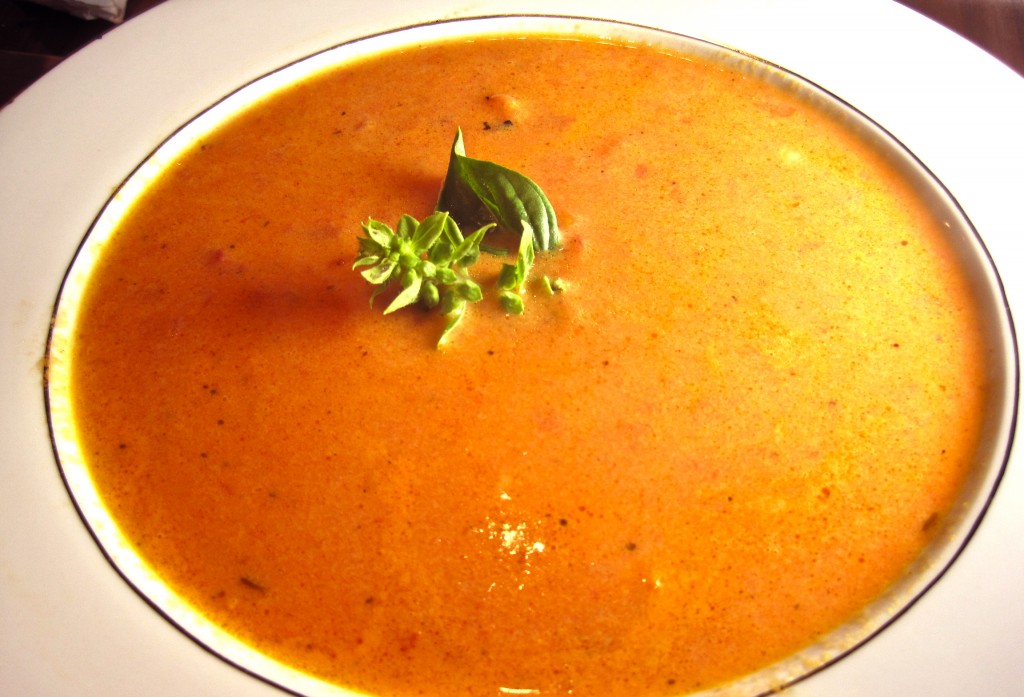 Bowl of Homemade Tomato Soup with Basil Garnish