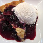 Slice of Warm Blueberry Pie with Vanilla Bean Ice Cream